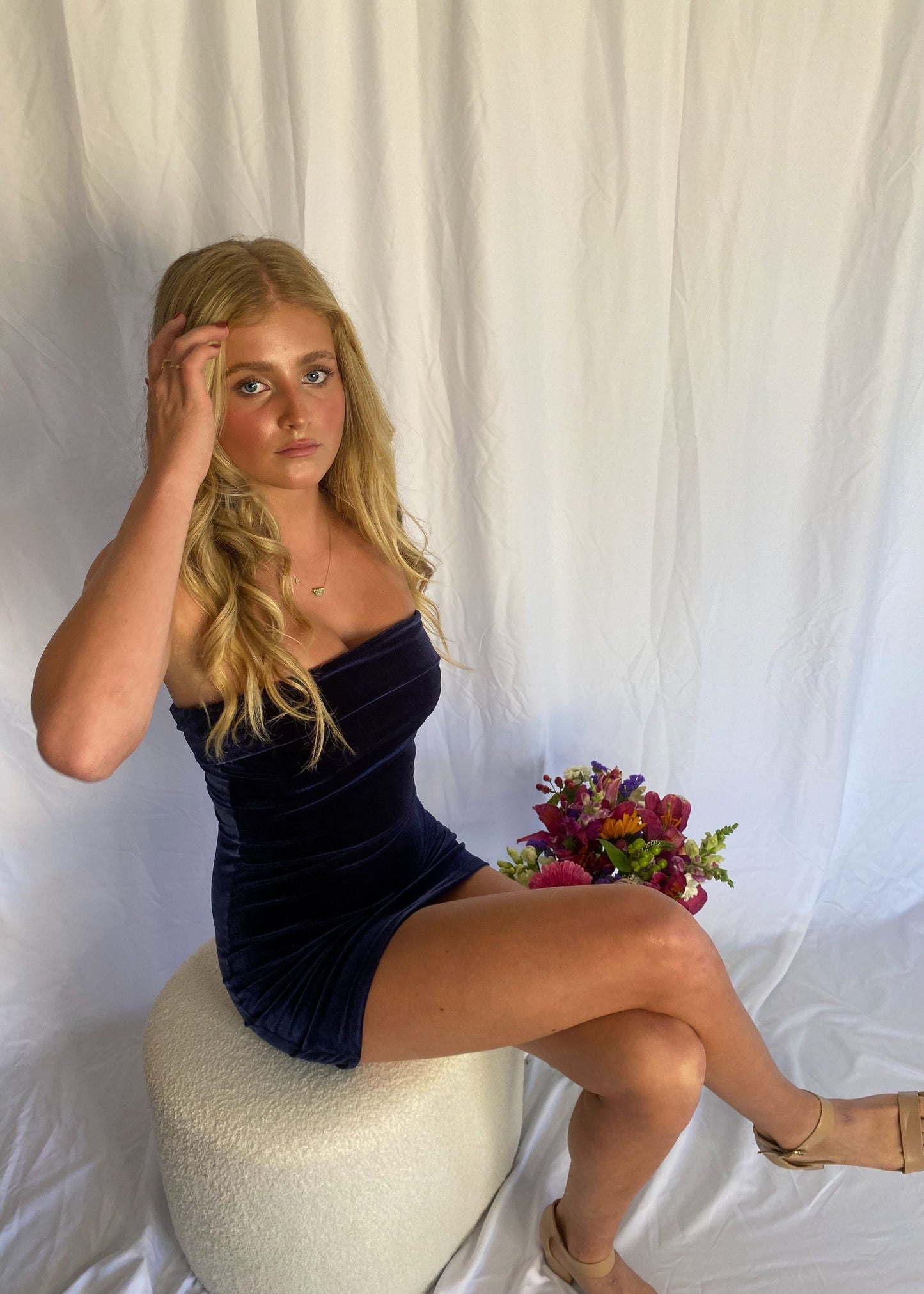 7th and York Strapless Mini Dress in Midnight (Navy), Velvet Material. Perfect for events like the races, birthdays etc. Size 8/S dress. Sitting on chair slightly above view of dress