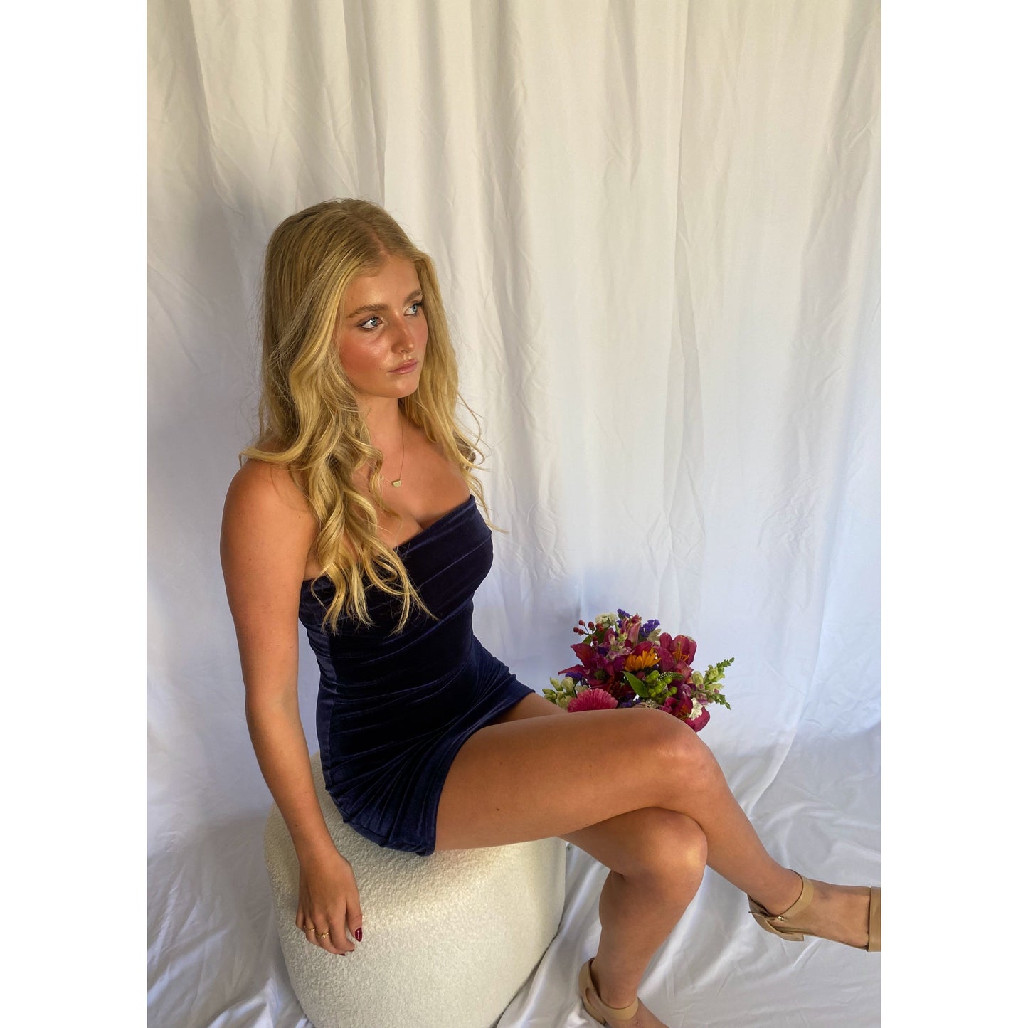 7th and York Strapless Mini Dress in Midnight (Navy), Velvet Material. Perfect for events like the races, birthdays etc. Size 8/S dress. Sitting down on chair view off dress