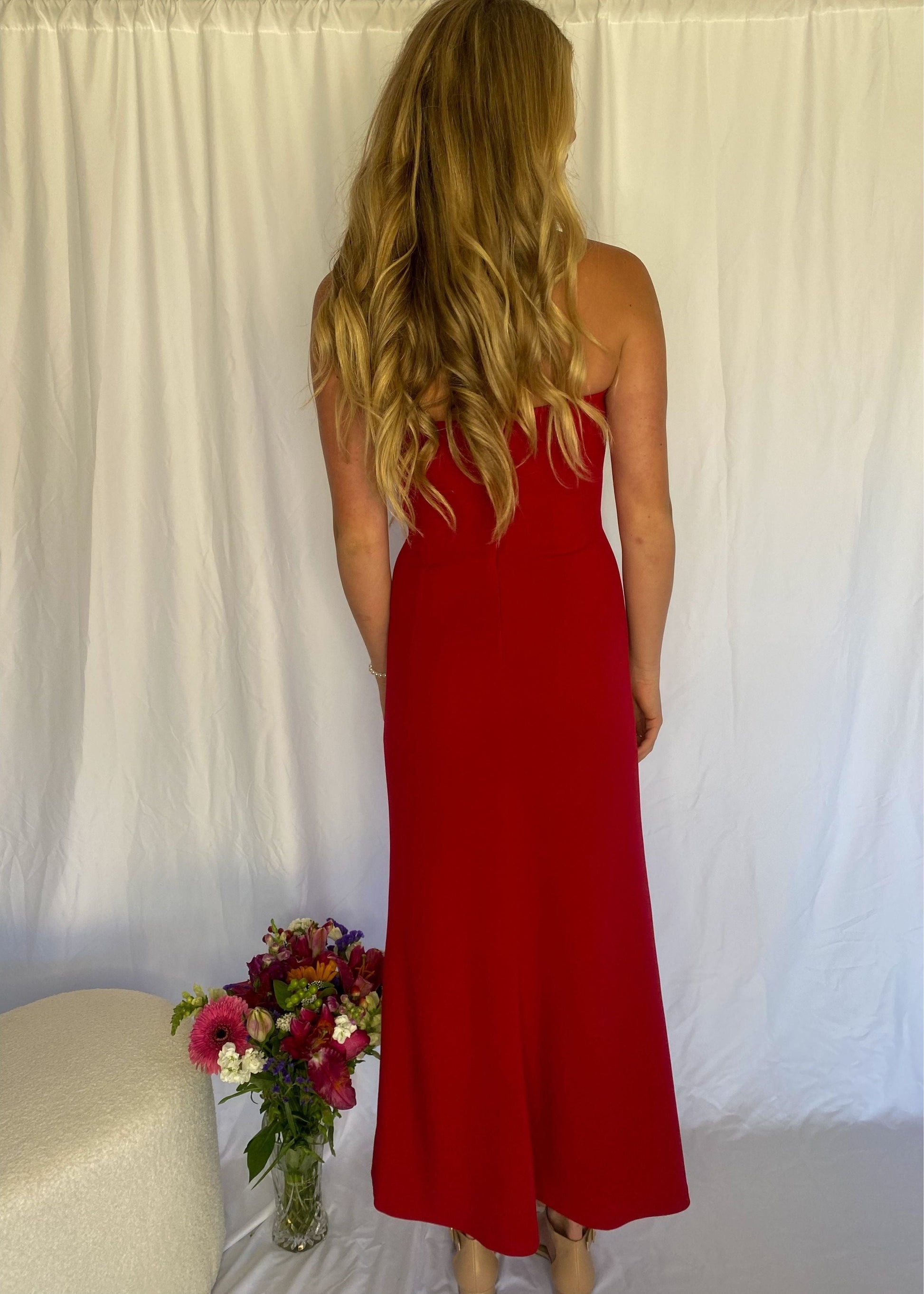 xRed strapless full length dress. Top bit of dress has boning like a corset an zip up back. Size XS best fitted to a 8 - small 10. Front on view of the back of the dress