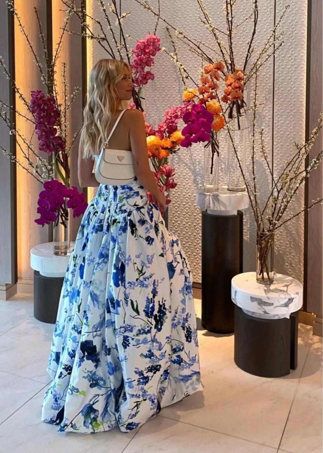 Aje Violet Bubblehem Maxi Dress in Blue Floral, Size 8. Zip up back. Side split on leg up to mid thigh. Tight fitting (with stretch) bust and torso and puffy bottom. Back side view off the dress.