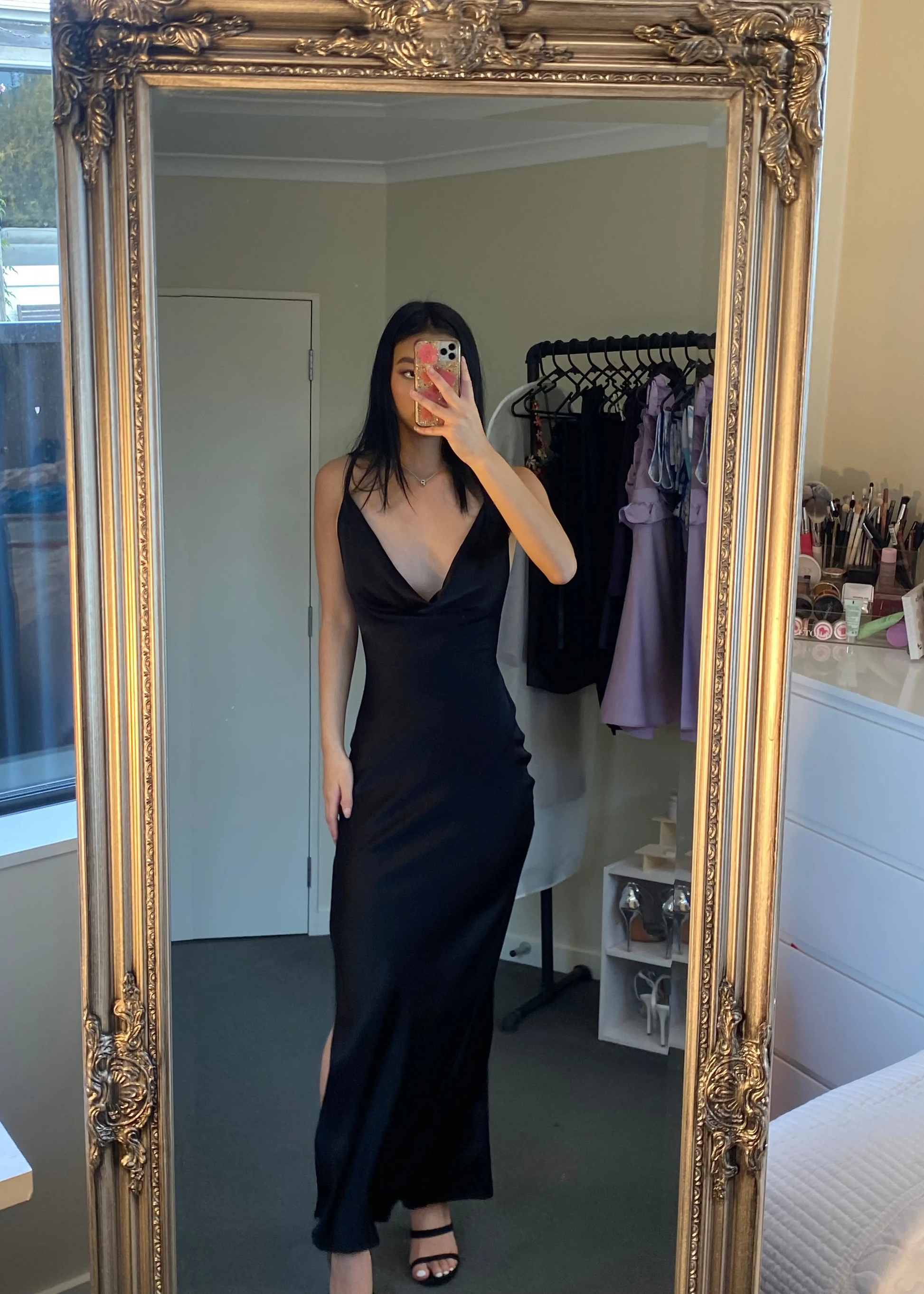 Johannah Cowl Midi in Black, Size 8. Featuring an asymmetrical design with a low cut bust area and low draping back with slight adjustability of strings tying at bottom of back area. Perfect for formal events. Front on view of dress over two shoulders