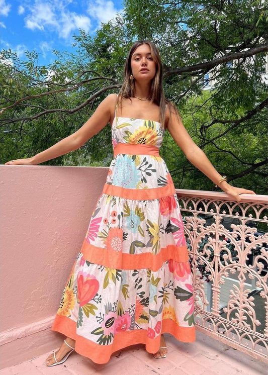 By Nicola Monet Tiered Maxi in Melon, Size 12. Featuring 4 horizontal stripes in melon and a floral design in between the stripes with a big bow to tie at back of bust area. Perfect for weddings, cocktail evenings and garden parties etc. Front full length view of dress.