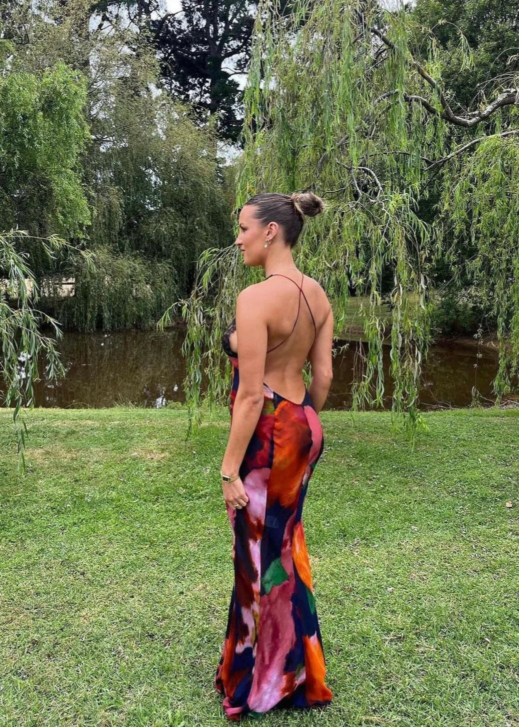 Rat and Boa Paola Maxi Slip Dress, Size L. Featuring a moody, abstract floral print and finished with delicate black lace detailing, it's a floor-skimming slip with delicate, criss-crossing straps and a daringly low-cut back. Perfect for formal events. Back full length view of dress.