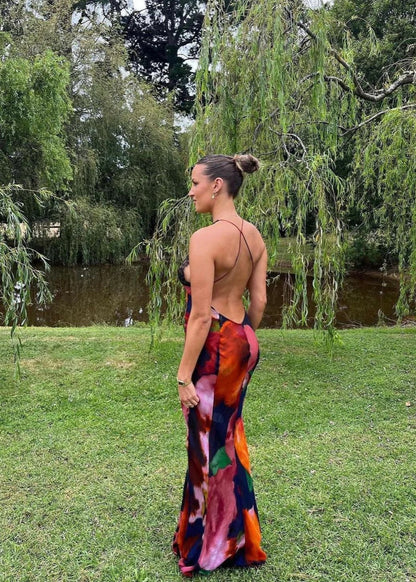 Rat and Boa Paola Maxi Slip Dress, Size L. Featuring a moody, abstract floral print and finished with delicate black lace detailing, it's a floor-skimming slip with delicate, criss-crossing straps and a daringly low-cut back. Perfect for formal events. Back full length view of dress.