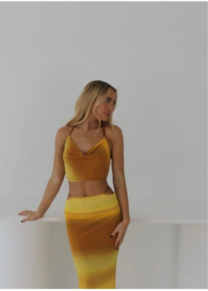 Bec and Bridge Amara Set in Ombre Yellow/Mustard, Size 6.  Adjustable top at back and skirt with zip. Perfect for summer events with a semi tight fit and breathable fabric. Front on view of set not full length picture ends around knee height