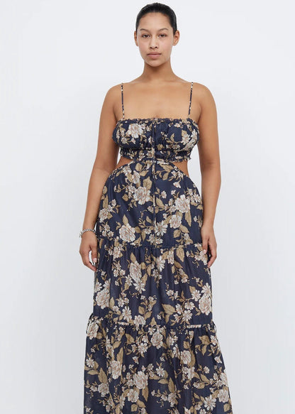 Bec and Bridge Alexandra Tie Maxi Dress, Size 16. Navy with some floral patterning that is cream/light brown. Thin flowy material. Small stomach cut outs on the side. Slightly adjustability at back and very stretchy. Front on view of dress