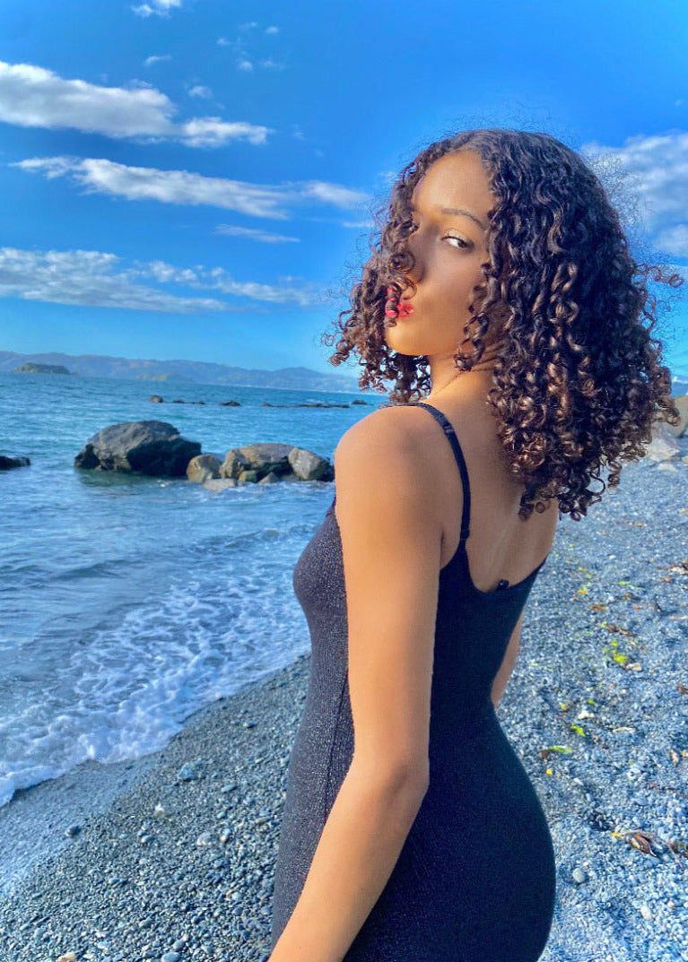 SKIMS Long Slip Dress in Shimmer Onyx, Size S. Featuring a body hugging fit, straight neck and adjustable spaghetti straps. Featuring a gorgeous shimmer detail on the dress. Can be dressed up or down. Back view of dress.