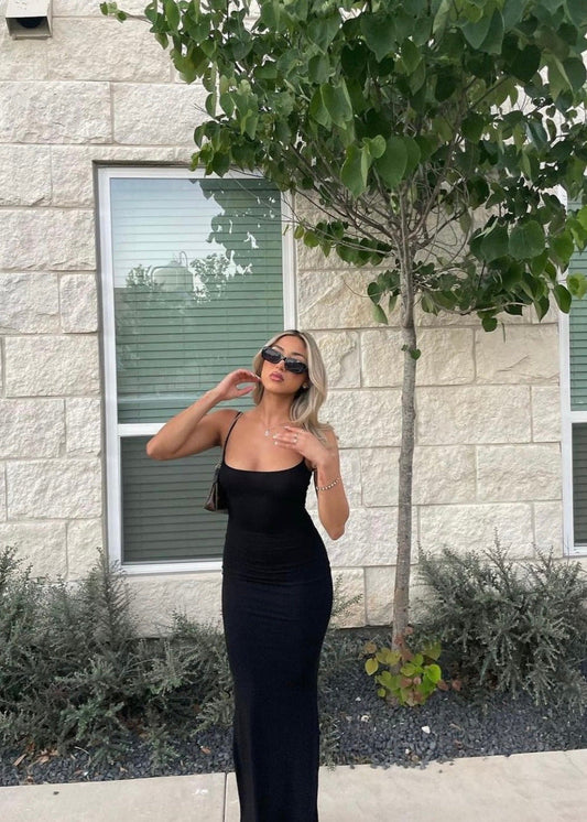 SKIMS Long Slip Dress in Onyx, Size XS and M. Featuring a body hugging fit, straight neck and adjustable spaghetti straps. Can be dressed up or down. Front on view of dress.