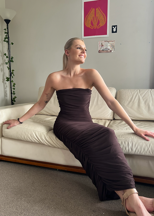 Ruby Ginni Mesh Tube in Chocolate Brown, Size 8. Featuring a strapless design with gathered side seams that create ruching that gently accentuate the contours of your silhouette. Perfect for formals, weddings, races, wineries, birthdays etc. Front on sitting down view of dress.