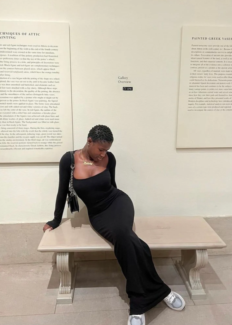 SKIMS Long Sleeve Slip Maxi Dress in Black, Size S. Featuring a Front Square Neckline, Maxi Length, Comfortable, Body-Hugging Fit, Ribbed Fabric Detail. Can be dressed up or down. Front on sitting down view of dress.