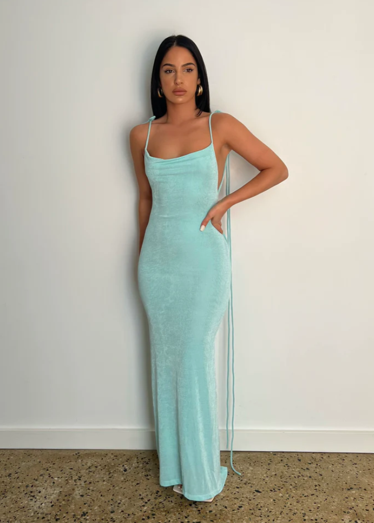 Melani the Label Cristinaa Gown in Aqua, Size 6/XS. Featuring a stunning draping low back with very adjustable straps to have the front lower or higher depending on preference the strap strings also cascade down the back of the dress which has a small train depending on your height. This is a tighter fitting dress. Perfect for formal events. Front view of dress.