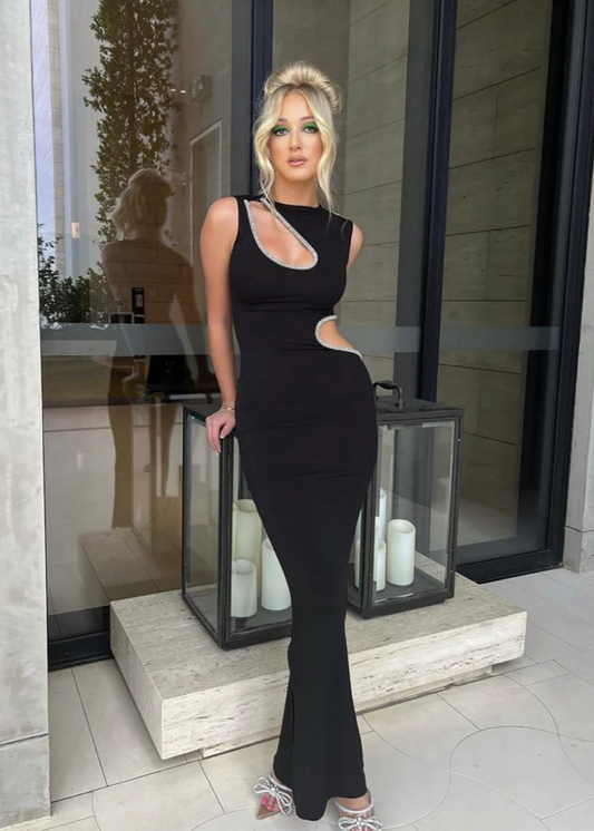 Ivona Skelo Vivia Dress in Black with Crystal Cut Outs, Size 8/S. Featuring two cut outs one at the waist and one at opposite shoulder the edge of both cut outs is covered with crystals. Perfect for formal events. Front of full length view of dress.