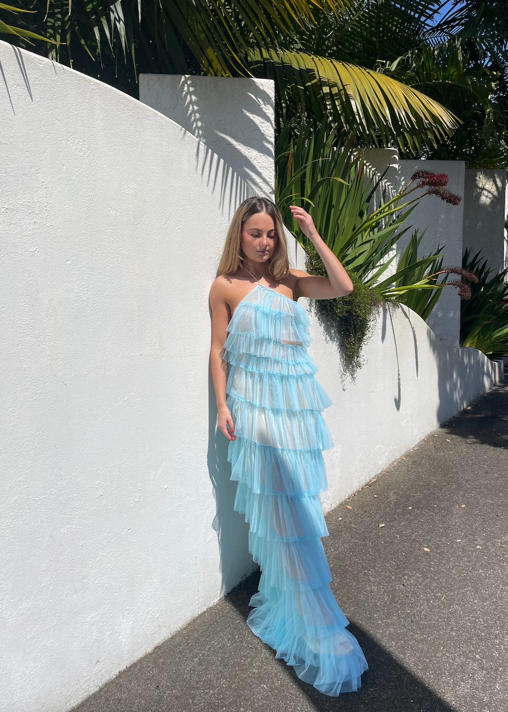 The Bar Henri Gown in Blue, Size US4 (AU8). Featuring Layered tulle fabric with a halter neck tie, side zip closure and side split. Semi Sheer but comes with a nude mini skirt that can be worn under. Perfect for formal events. Front on full length view.